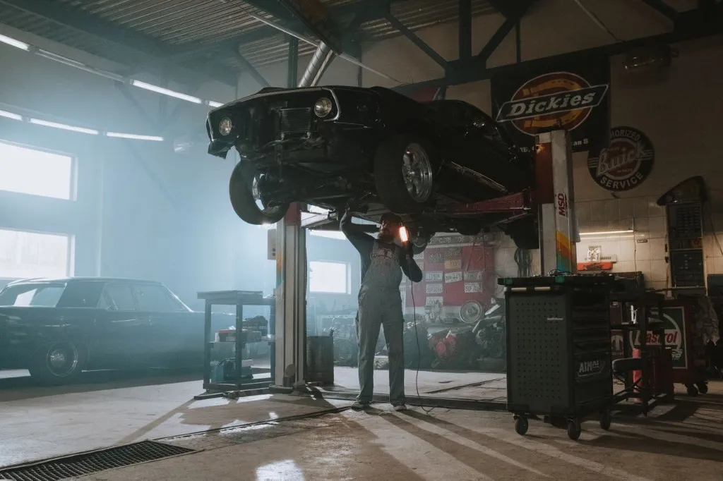 A technician performing service at I CARE Automotive